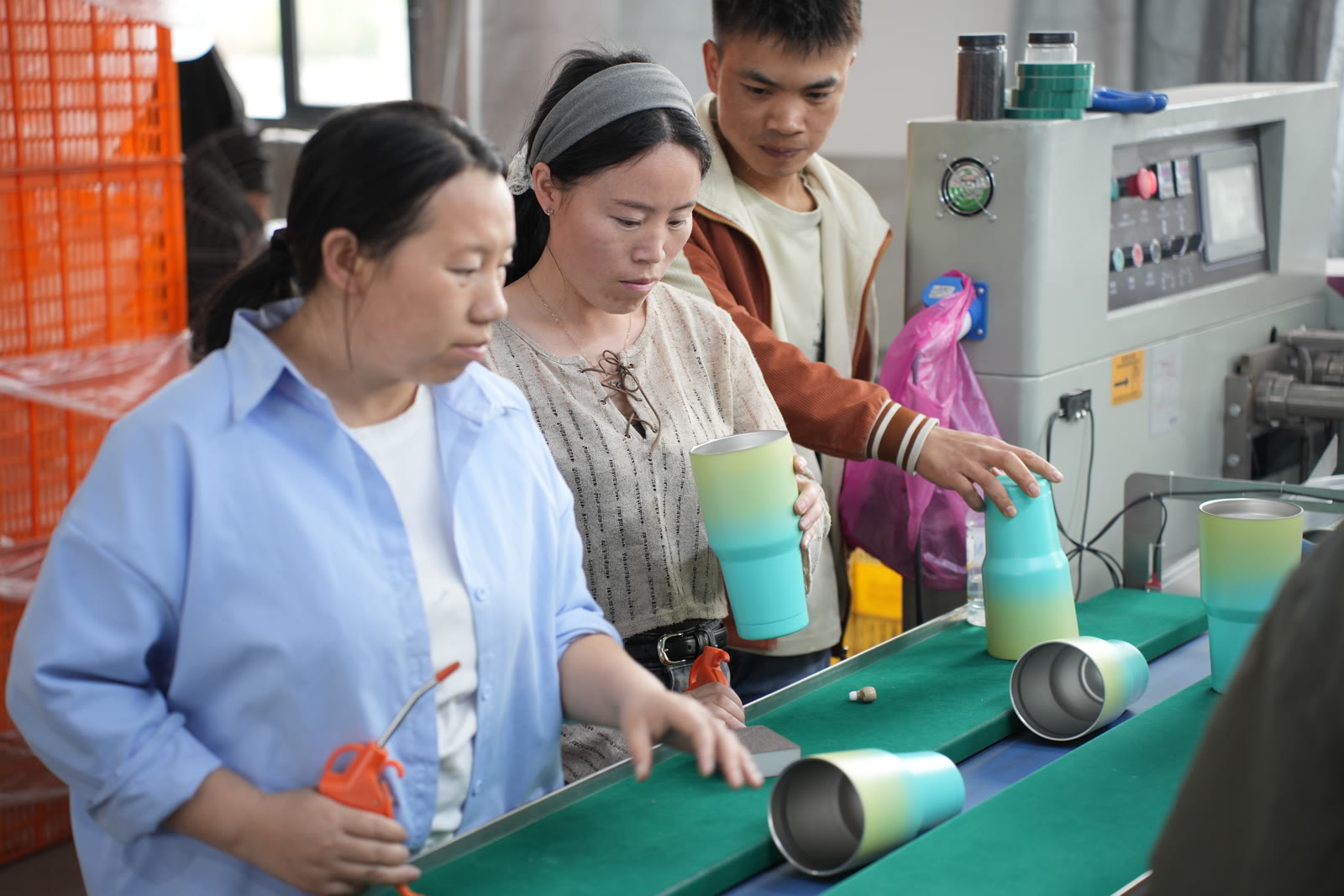 QC team inspecting finished gradient tumblers for quality