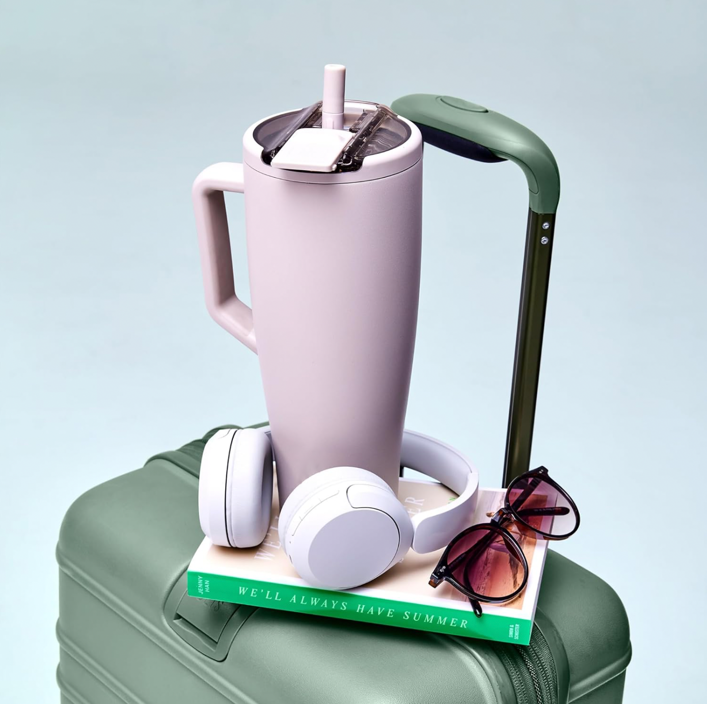 BrüMate Era tumbler in lavender on a suitcase — the lifestyle aesthetic that helped the brand go viral